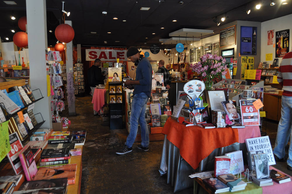 A customer browses the diverse book selection at Outwrite on the iconic bookstore’s final day at its Midtown location.