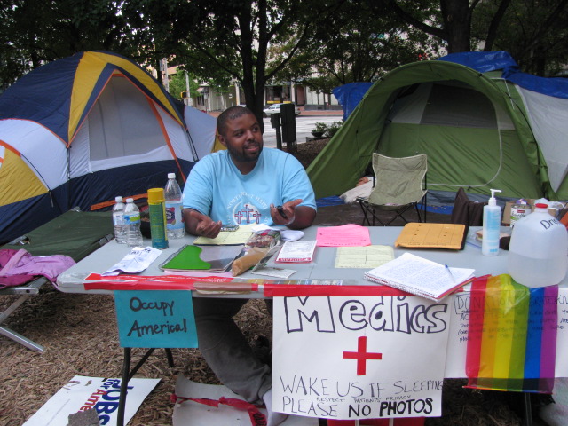 +OCCUPY+ATLANTA+PROTESTERS+SET+UP+TENTS%2C+COMMUNITY+IN+WOODRUFF+PARK%3A+On+Oct.+7%2C+hundreds+of+protesters+converged+on+Woodruff+Park+to+express+their+anger+at+a+variety+of+economic+and+political+trends.+They+remained+in+the+park+until+Oct.+26+and%2C+inspired+by+Occupy+Wall+Street%2C+called+their+movement+Occupy+Atlanta.+Jason+Woody%2C+a+business+owner+from+East+Point%2C+Ga.%2C+joined+the+movement+because+he+related+to+the+stories+of+other+protesters%2C+many+of+whom%2C+like+Woody%2C+have+outstanding+student+loans.+%E2%80%9C%5BOur+goal+is+to%5D+make+people+aware+of+government+policies+%5Band%5D+the+unfairness+of+the+financial+system%2C%E2%80%9D+Woody+said.+%E2%80%9CWe+want+to+wake+people+up.%E2%80%9D+On+Oct.+16%2C+Woody+provided+first+aid+for+protesters+at+the+medic+tent
