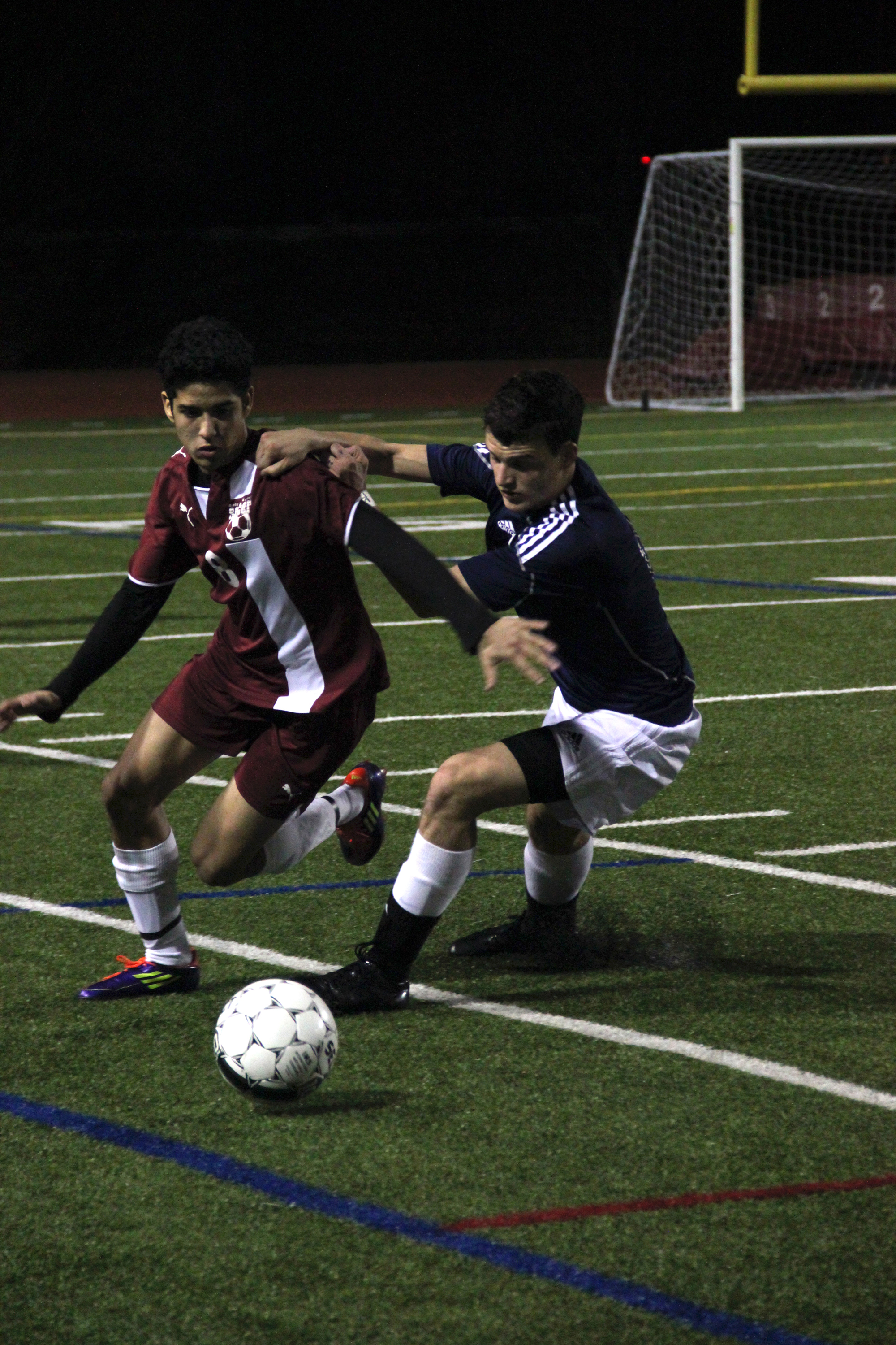 Senior winger Asa Eggleston dribbles past a Pius defender during the second half. Pius scored their second goal five minutes into the second half and added their third, and final goal, three minutes later. Photo by Lucy Leonard.