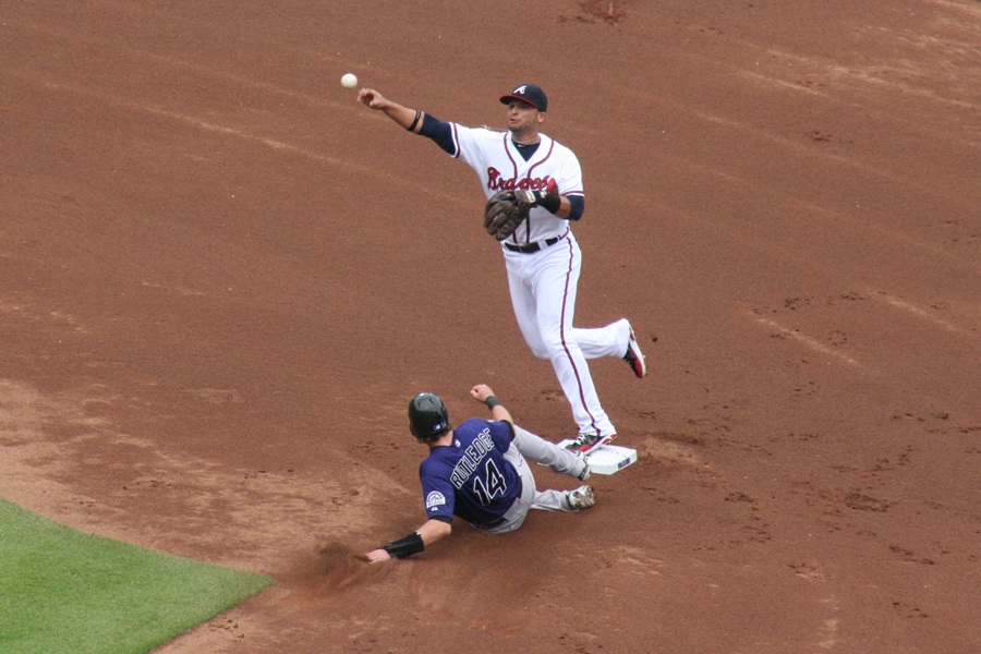 A PRADO MOMENT FOR THE BRAVES – Second baseman Martin Prado attempts to turn a double play in the bottom of the first. Carlos Gonzales, the Rockies left fielder, grounded to Braves shortstop Paul Janish who tossed to Prado to force Rockies player Josh Rutley at second. Usually the Braves left fielder, Prado has been playing at second in place of Dan Uggla and even started a game at shortstop this week (caption by Laura Streib). 