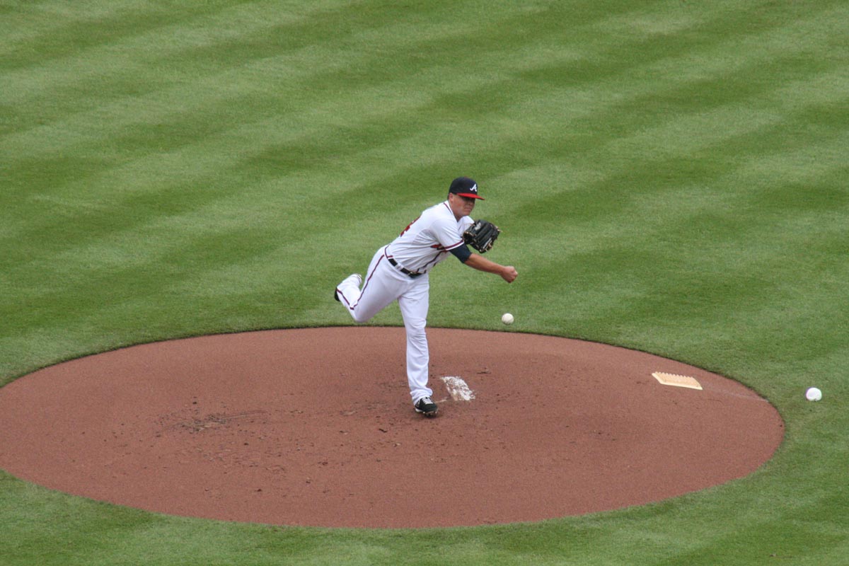 ABOUT FACE -- Attempting to keep a Colorado baserunner close to first base, Braves starter Kris Medlen hurls the ball to first baseman Freddie Freeman.  In the past 18 games that Medlen has started, the Braves have emerged as the victors, including Monday’s 6-1 win (caption by Kiana Stuckey).