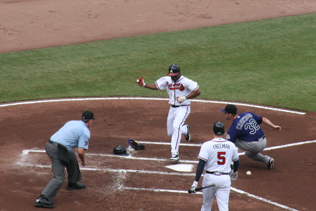 NOT PITCHER PERFECT – Braves center fielder Michael Bourne doesn’t need to worry about being tagged out when running home after a wild pitch by Rockies starter Tyler Chatwood. Chatwood doesn’t seem to notice the loose ball behind his left leg. This was the first run in the Braves 6-1 victory over the Rockies (caption by Patrick Wise).