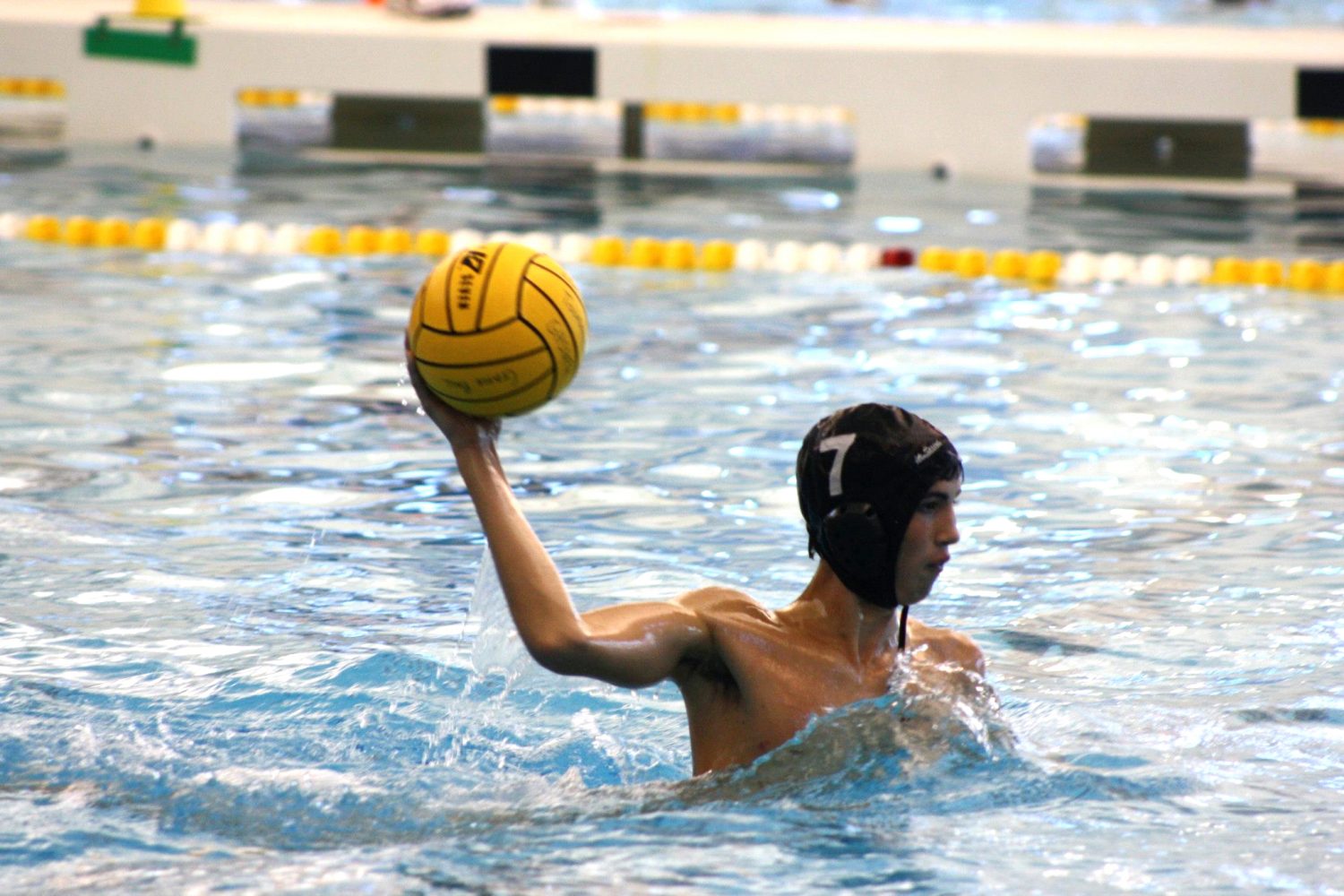 Senior Luke Paddock takes aim at the goal in a water polo game.