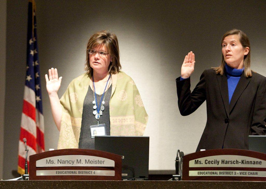 Cecily Harsch-Kinnane raises her right hand to take an oath of office for her position as APS board member. This began Harsch-Kinnanes second term on the board, which will end by the of this year.
