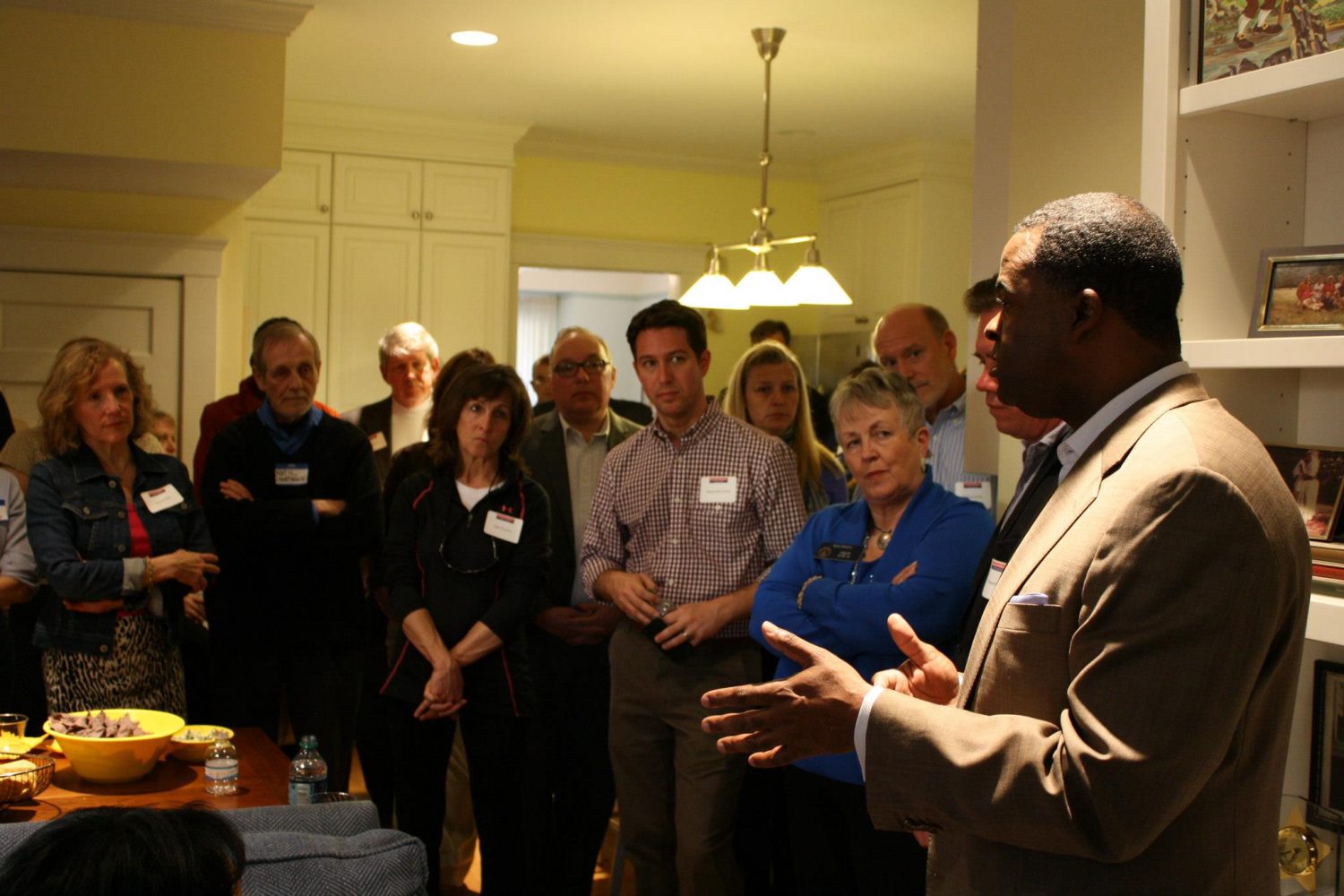 Atlanta Mayor  Kasim Reed (right) talks  to  attendees of a fundraiser about  his  goals  for his second term.
