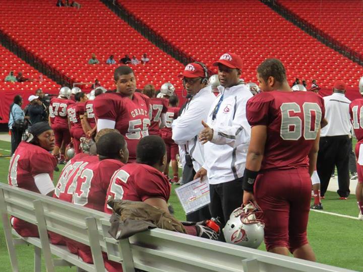 One of the Grady coaches talk to the Grady defensive line during an offensive drive.