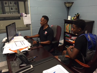 SCHEDULING GURU: Mr. Vincent helps senior Karlito Mays fix holes in his schedule