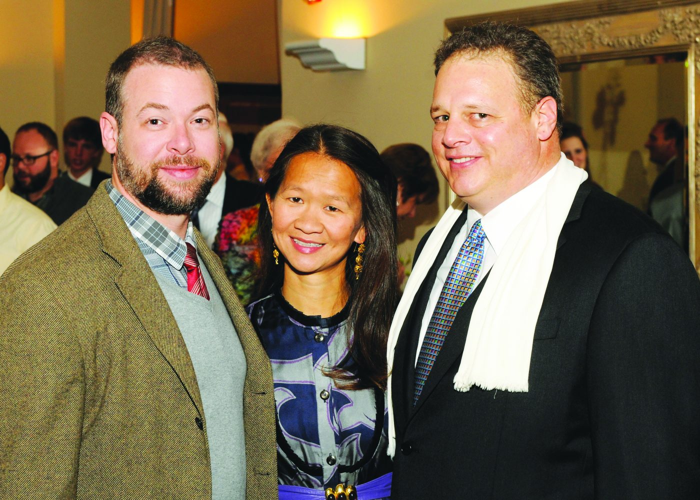 Trinh Huynh stands at mock trial fundraising event with the two other coaches, Brian Leah and Carol Gebo. Huynh was a coach of the team for 11 years.