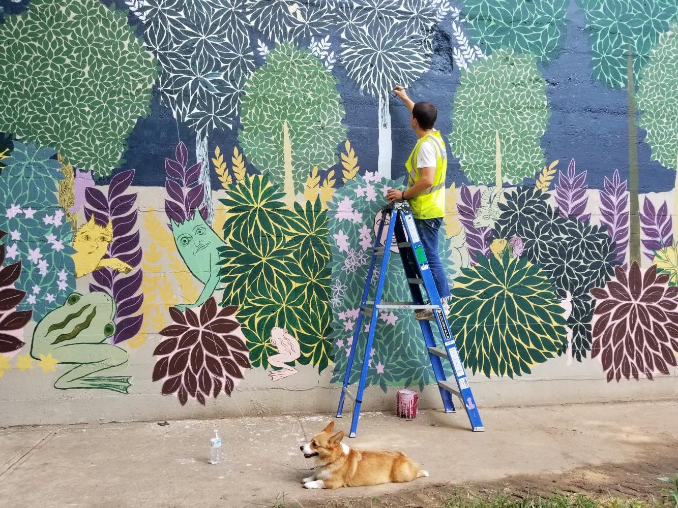 ARTIST AT WORK: Andrew Catanese, an Atlanta-based artist, works on his mural on the BeltLine beneath the Eastside Trail. Catanese paints murals in the “horror vacui” style. volunteer help.
