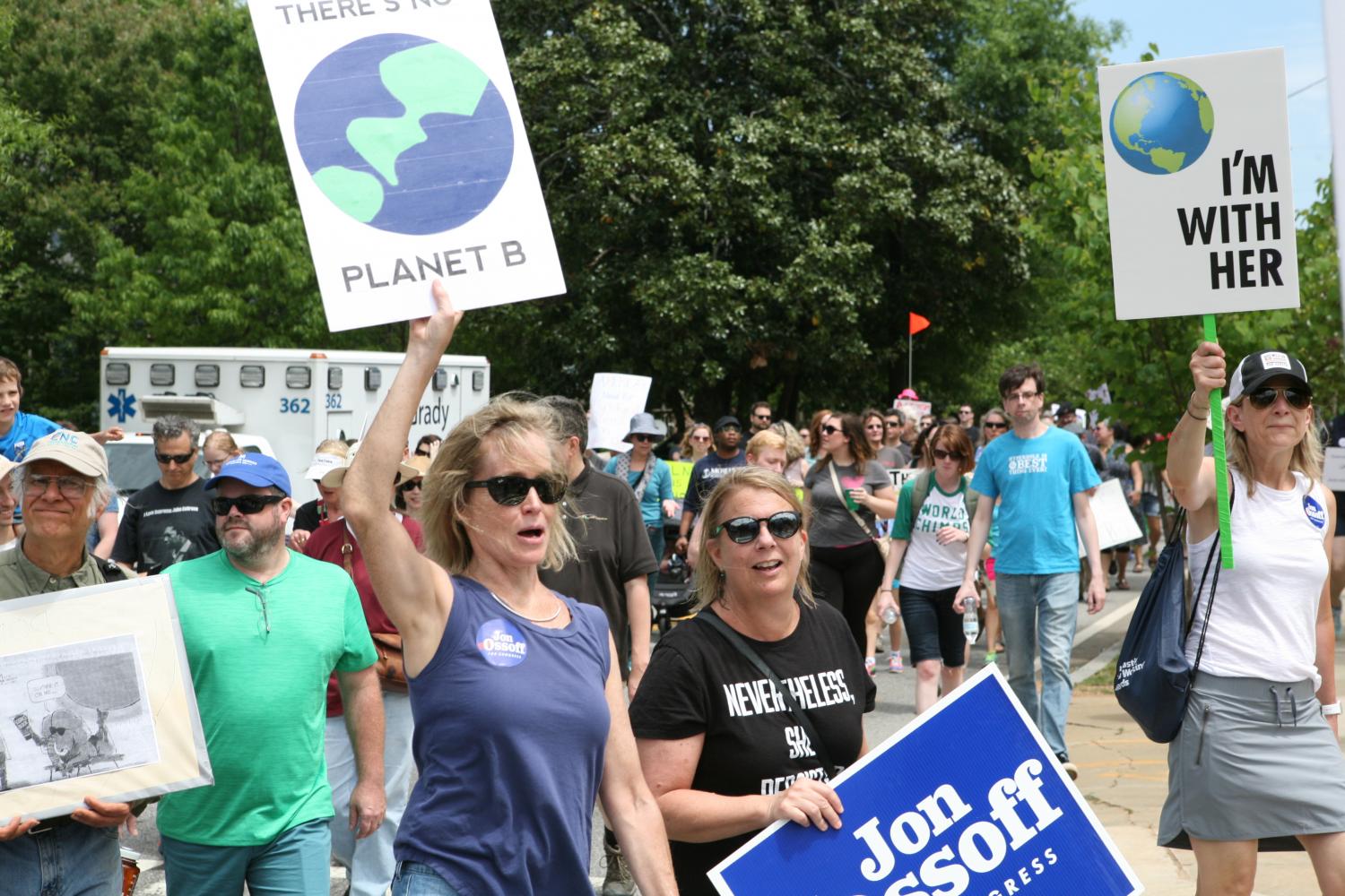 Marchers turn onto Euclid Ave in Candler Park carrying signs supporting environmental friendly policy. Some marchers took a more political stance, carrying signs reading supporting Jon Ossoff. 