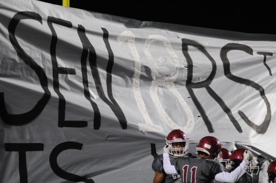 Grady takes the field while ripping through a 'Sen18rs' banner