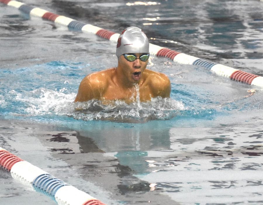 Sophomore Sebastian Gerz-Escandon comes up for a quick breath during a breaststroke race at a Tri meet at the Washington Park Natatorium pool on Nov. 14. 