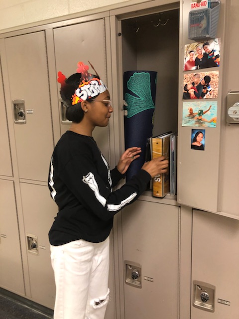 Junior Storm Wright gets books our of her locker. She is one of the few upperclassmen who utilize the lockers.