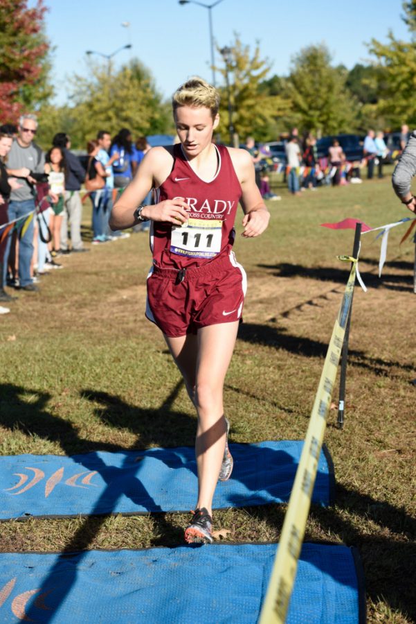 FINISHING STRONG: Sophomore Lindsay Shroeder runs through the finish line in the region championship cross country meet on Oct. 26, 2017 at Boundary Waters. He finished 6th, helping Grady win the meet.
