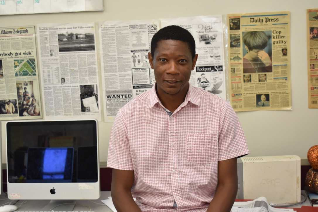 IN HIS ELEMENT: Journalism adviser Del Ellerton sits in the journalism classroom surrounded by examples of newspapers from his years of experience as a writer. Ellerton was a writer for the Macon Telegraph, the Daily Press, the Atlanta Journal-Constitution and Bloomberg News for 10 years.