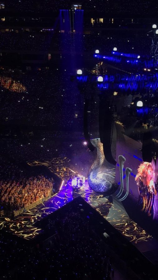 Taylor Swift performing Look What You Made Me Do with a with a giant mechanical snake at her show at the Mercedes-Benz Stadium.