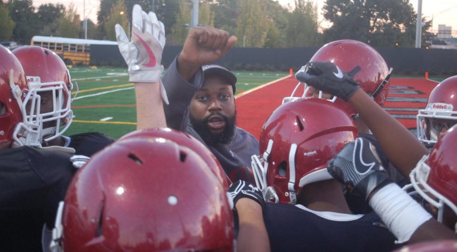 Head coach of the JV team, Coach Anderson, motivates the team as they come in for a huddle in the last 30 seconds of the half-time.