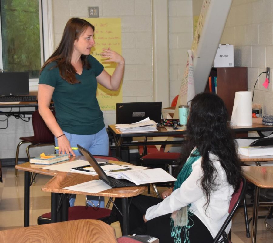 A TEACHING MOMENT: ESOL teacher Katherina Maryska explains a concept to senior Sabiha Akter. Akter is from Bangladesh where the official language is Bengali. Maryska uses body language to aid in learning. 