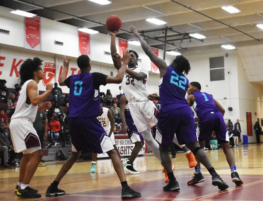 HARD IN THE PAINT: Junior Dewan Wright shoots the ball surrounded  by the South Atlanta Hornets on Nov. 13. This is Wright’s second year on varsity. He is a 6’5 powerhouse. 