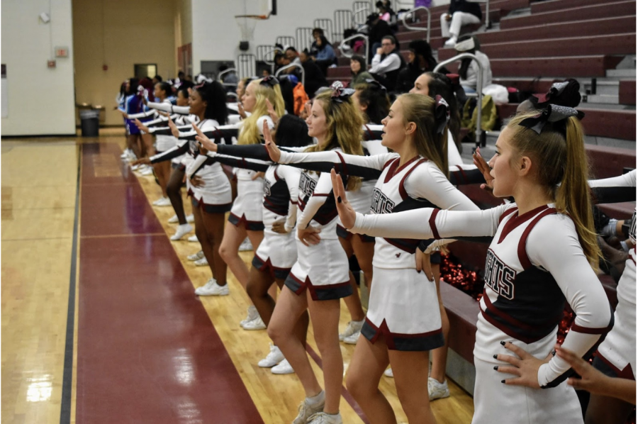 The cheerleaders cheer on he boys basketball team  in the a scrimmage game against South Atlanta on Nov. 13. The cheerleaders are required to attend every game. 