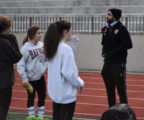SOCCER SEASON: Member of the Junior Varsity Girls soccer team prepares for the upcoming season by talking to coach Hamel Patel. This new JV team offers freshmen a place to hone their skills as they prepare to play varsity in their coming years. 