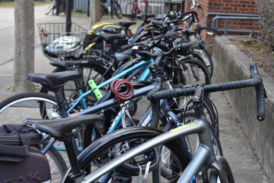 Several bikes crowd the racks near the courtyard.