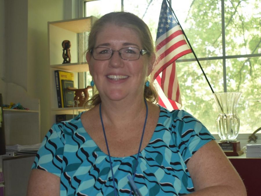 Grady social studies teacher of 26 years, Mary Van Atta, smiles as she sit in her classroom.