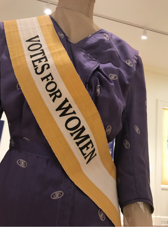 An example of what a suffragette might have worn is displayed in the center of the main exhibition room. “Votes for Women” are proudly stitched across this sash. 
