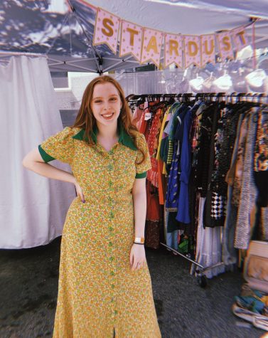 In addition to selling her vintage clothes online, Bella does local popups and festivals. Here, she poses in front of her booth at the Atlanta Fila Fest.