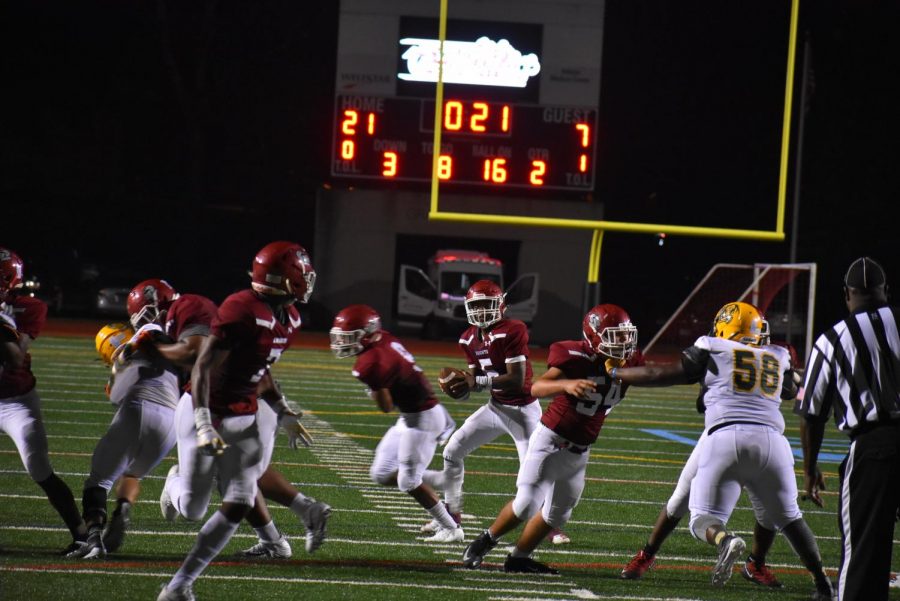 Senior quarterback Aquinas Stillwell looks to find senior tight end Dewan Wright over the middle to extend the Knights lead in the second quarter.