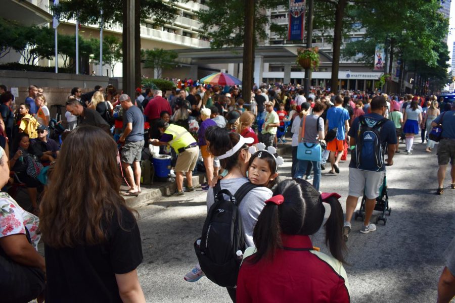 The crowd sparks chaos as people circulate Peachtree Street. Many parents and children attended the event, such as the young girl peering over her mother’s shoulder.