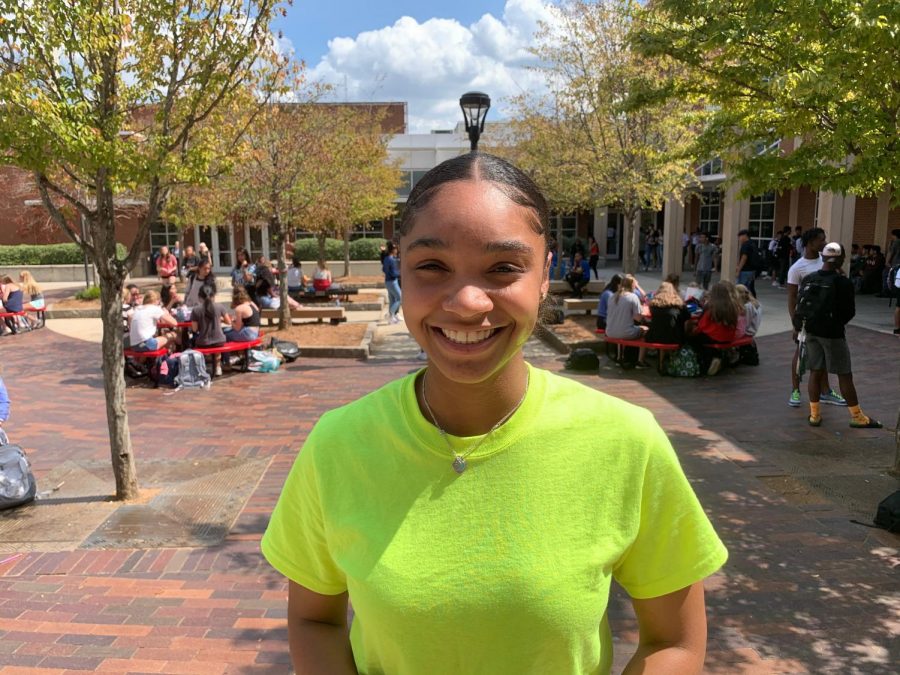 Taylor Spencer, a candidate for Executive President, smiles as she stands in the courtyard. 