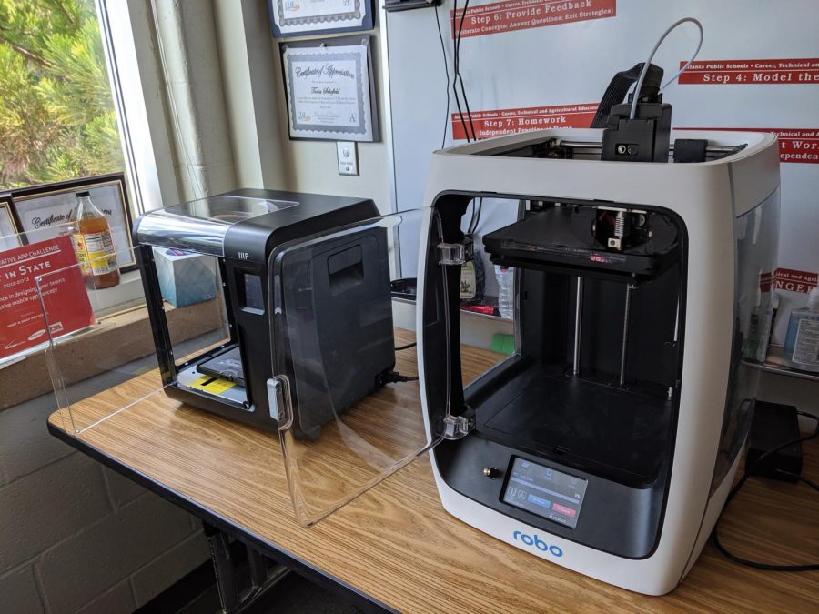 Newly installed 3D printers sit on a table in the engineering room, they were just installed last week near the end of the first week of school.