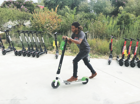 SCOOTING ALONG: Johan Hood, employee at Mint Salon, rides a Lime Scooter on the BeltLine near the intersection of 10th Street  and Charles Allen Drive. E-scooters have become a popular form of transportation in Atlanta since their introduction in 2018. Hood uses the scooters as a form of stress relief.