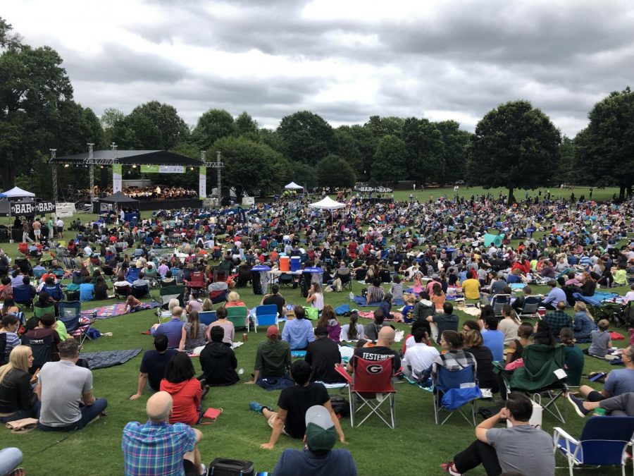 The Atlanta Symphony Orchestra performs on Piedmont Park's Oak Hill while a large crowd of listeners enjoy Tchaikovsky's Fifth Symphony.  Concerts are one of the many PPC sponsored community events that take place at the park throughout the year.