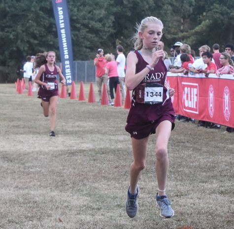 FOR THE WIN: Sophomore Ellie Spears strides down the chute finishing first in the APS City Championship meet on Oct. 8. The Knights’ finished first overall, sweeping the meet with the first five finishers. 