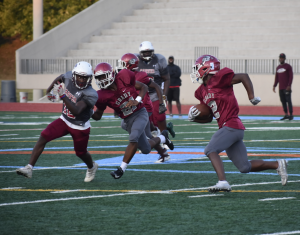 Freshman Jumal Prothro runs from a Carver defender in an attempt to score a touchdown for Grady.