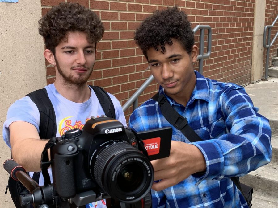 Junior Rylan Neil pictured filming a video for GNN with another videographer.