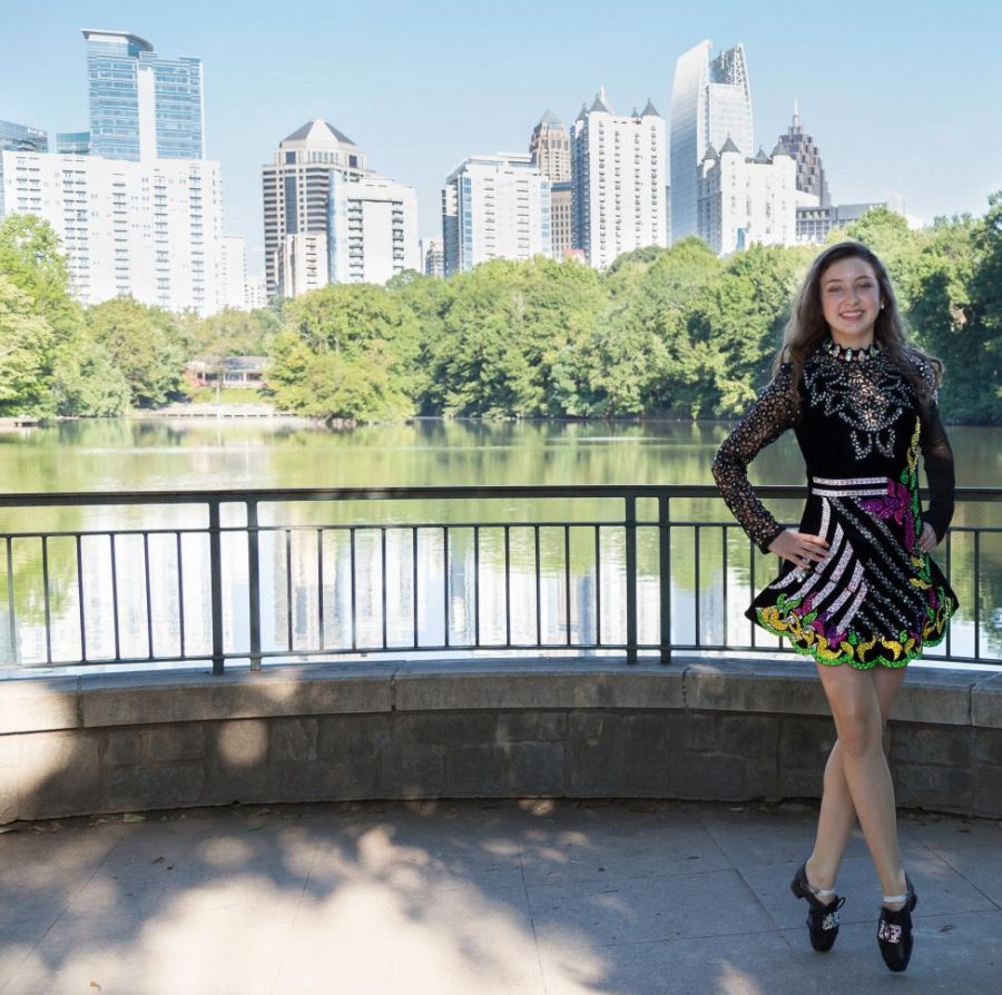 Sparkle and Bling: Freshman Aisling Mahony stands in Piedmont park for a photoshoot in her Irish dancing costume. The costume is one of her favorite parts of Irish dancing.