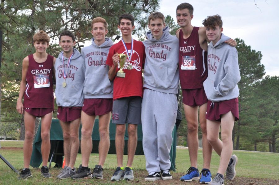 The boys cross country team celebrates winning the second place trophy at the 2019 Region 6AAAAA meet. Many of these athletes also compete on the track team, one of the many sports greatly affected by the COVID-19 outbreak. Five out of the seven pictured are seniors.