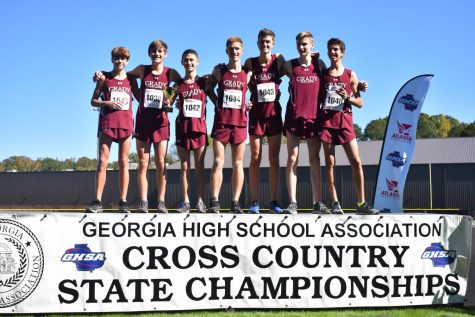 STATE RECOGNITION: The boys cross country team stands proud on the podium at the state 5A meet after finishing third overall. Two of the Knights seniors Kavi Jakes(8th) and Bram Mansbach(5th) finished in the top 10 for the boys in the meet. 