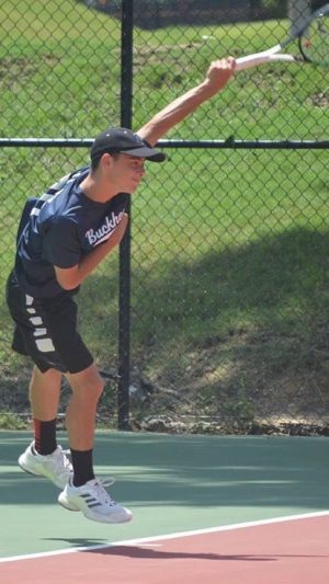 Scott Whitley serves to an opponent during a tennis invitational in the spring of 2019. During the spring, almost every day of Whitleys week is taken up by sports -- either tennis or ultimate.