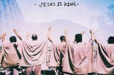 Members of Kanye Wests choir stand in front of a crowd during a Sunday Service performance.