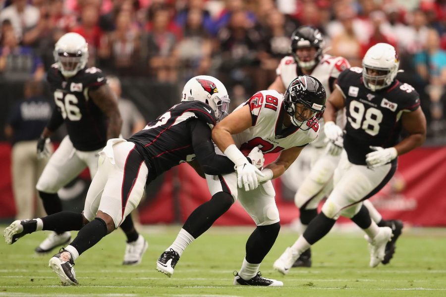 Falcons Tight End Austin Hooper is being tackled by defenders of the Arizona Cardinals. The Falcons would end up losing this game after a heartbreaking missed extra point by kicker Matt Bryant, making them 1-5.