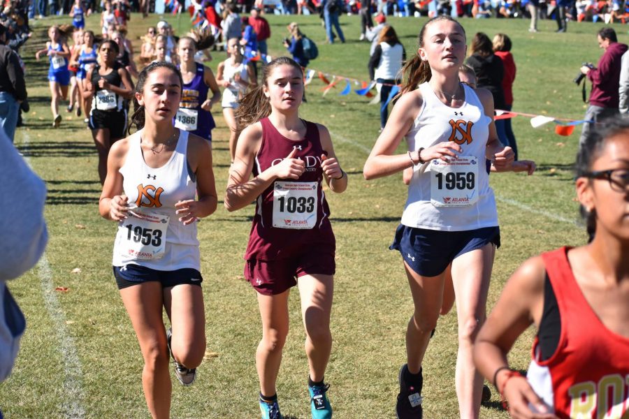 Junior Sadie Zweben races against two other competitor from North Springs in the state 5A meet. Zweben finished 92nd overall and 7th for the Knights. 