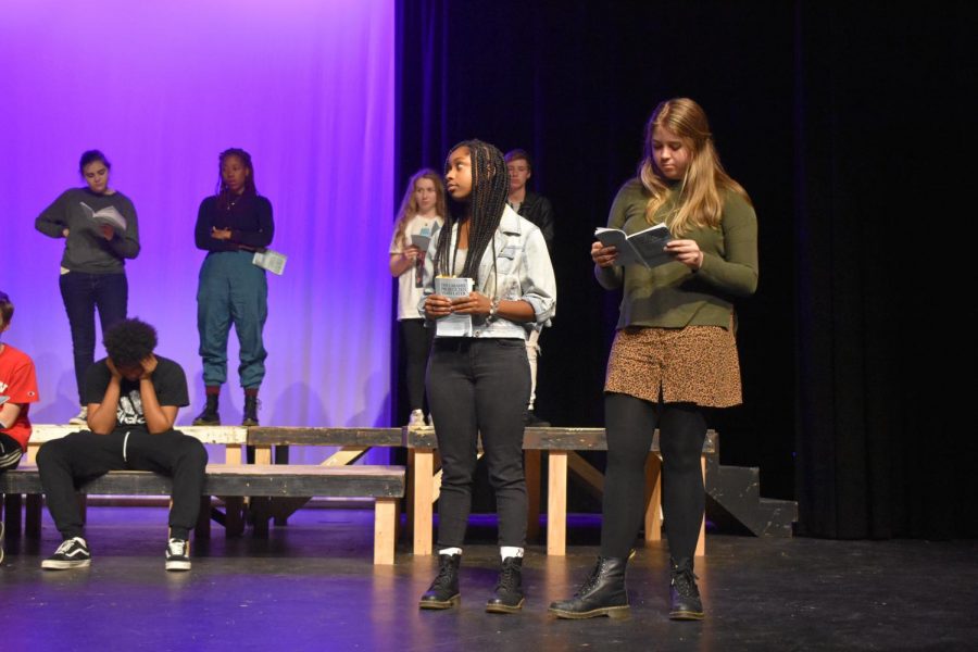 Seniors Madison Ford (front left) and Eden Artelli (front right) rehearse a scene during which legislators debate the Defense of Marriage Act, an act defining marriage as between a man and a woman. The act was ultimately struck down, which was viewed as a victory in the wake of Matthew Shepard's murder.