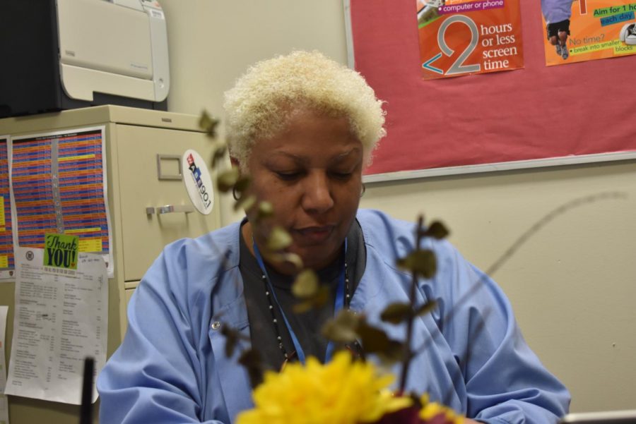 Nurse Wanda Taylor sits in her office as she fills out paperwork for the end of the day.