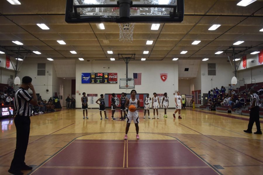 Senior Kyle Hanson takes a free throw after a KIPP player was charged with a technical foul. In high school basketball, as well as college and professional, the eight other players on the court are required to stand behind the half-court line.