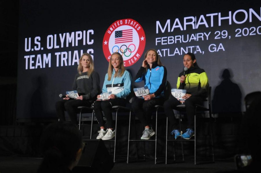 Left to right: Top seeded runners Kellyn Taylor, Emily Sisson, Sara Hall and Des Linden sit onstage as Linden answers a question from a high school runner in the crowd. Linden finished second at the 2016 U.S. Olympic Team Trials – Marathon in Los Angeles, qualifying her for the Rio Olympic Games.