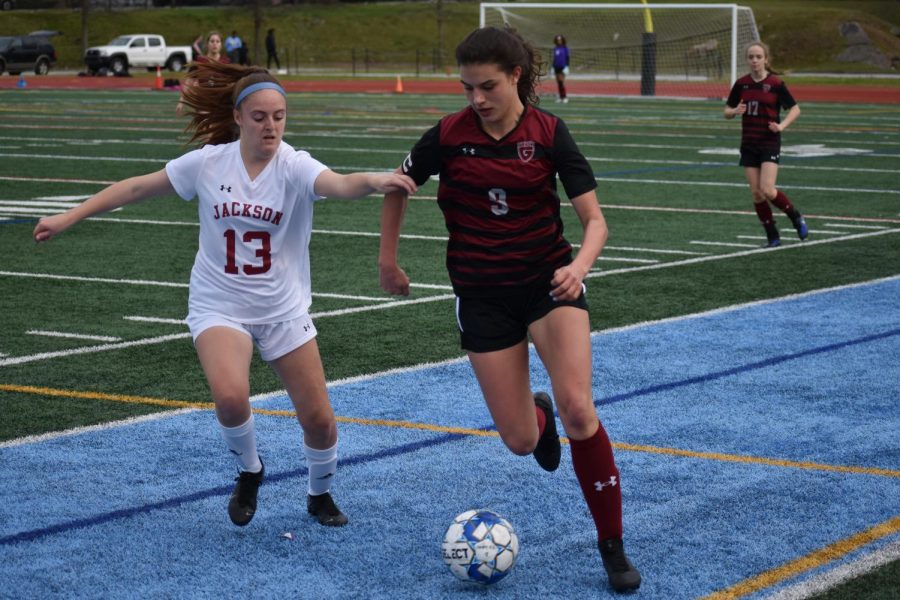Senior captain Kaitlin Palaian (right) dribbles down the sideline in the 3-1 victory over Maynard Jackson on March 9 where she scored two of the three goals. Palaian committed to the U.S. Military Academy in February 2019.